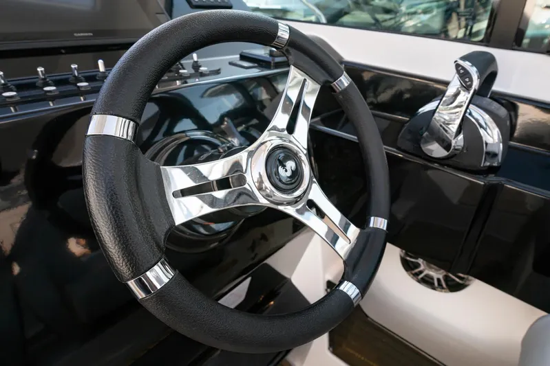  Yacht Photos Pics 2024 Beneteau Gran Turismo 32 Inboard steering wheel and controls, sleek design.