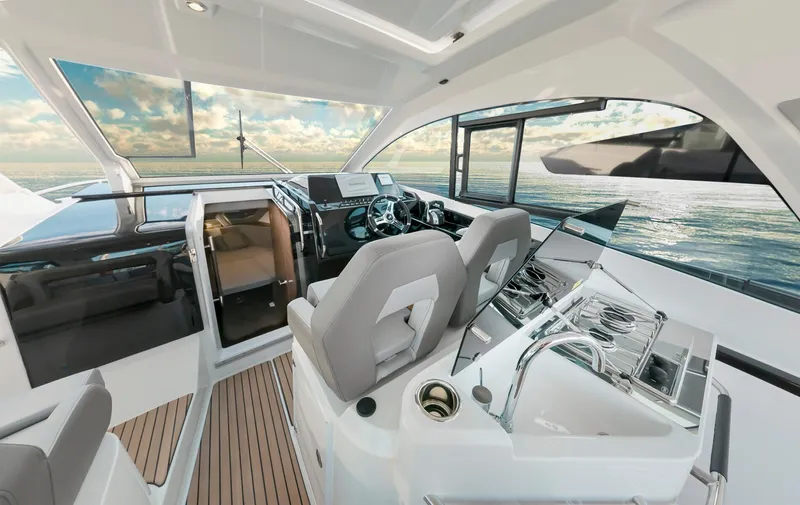  Yacht Photos Pics Interior view of 2024 Beneteau Gran Turismo 32 Inboard yacht, featuring modern helm and seating.