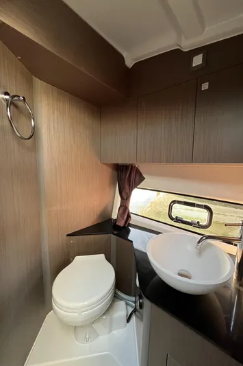  Yacht Photos Pics 2024 Beneteau Gran Turismo 32 Inboard bathroom with modern sink and toilet.