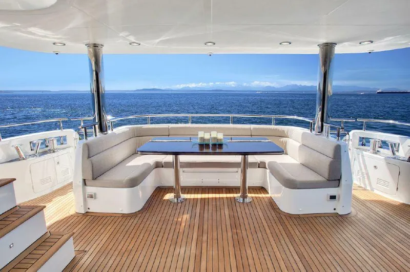  Yacht Photos Pics Luxurious Selene 92 Explorer yacht deck with ocean view, featuring elegant seating and table, 2026 model.