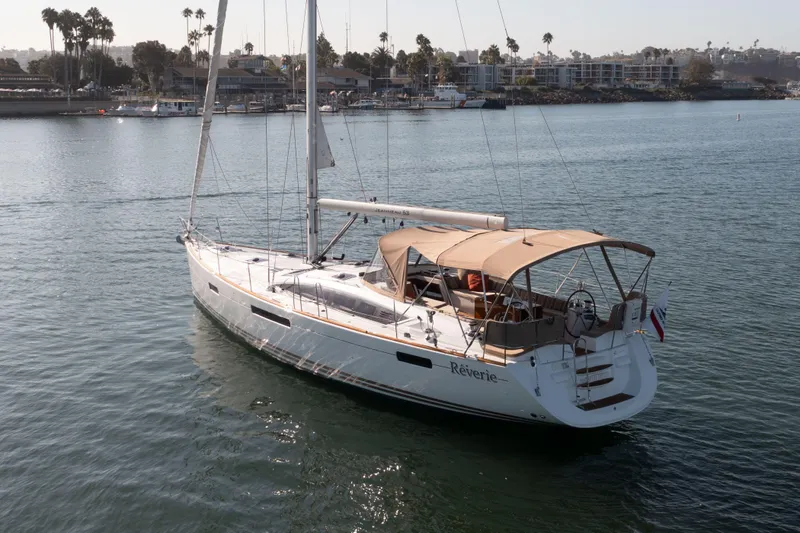 Shenanigans Yacht Photos Pics 2015 Jeanneau 53DS sailboat on calm water, featuring a sleek design and spacious deck.