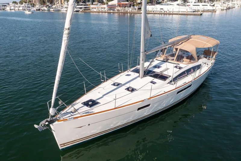 Shenanigans Yacht Photos Pics 2015 Jeanneau 53DS sailboat on calm water, featuring sleek design and spacious deck.