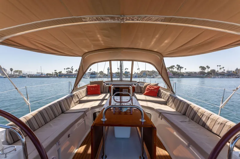 Shenanigans Yacht Photos Pics 2015 Jeanneau 53DS sailboat cockpit with canopy, spacious seating, and ocean view.