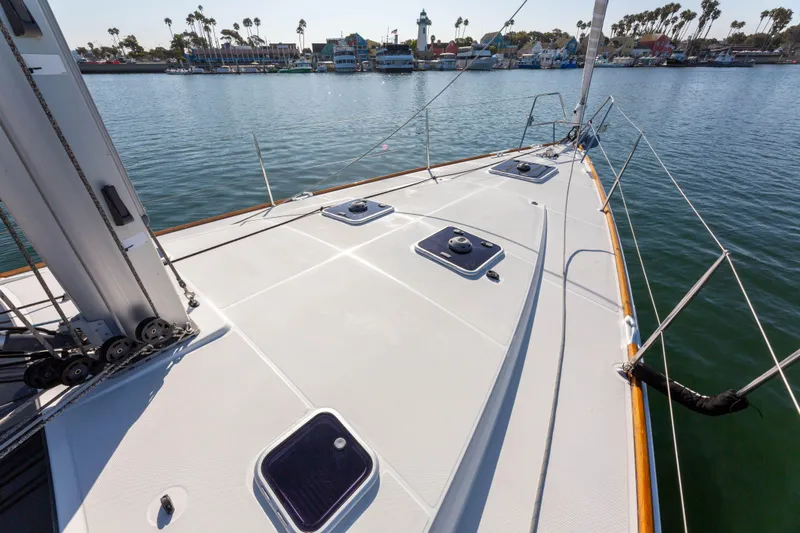 Shenanigans Yacht Photos Pics 2015 Jeanneau 53DS sailboat deck with hatches, docked in a scenic marina.