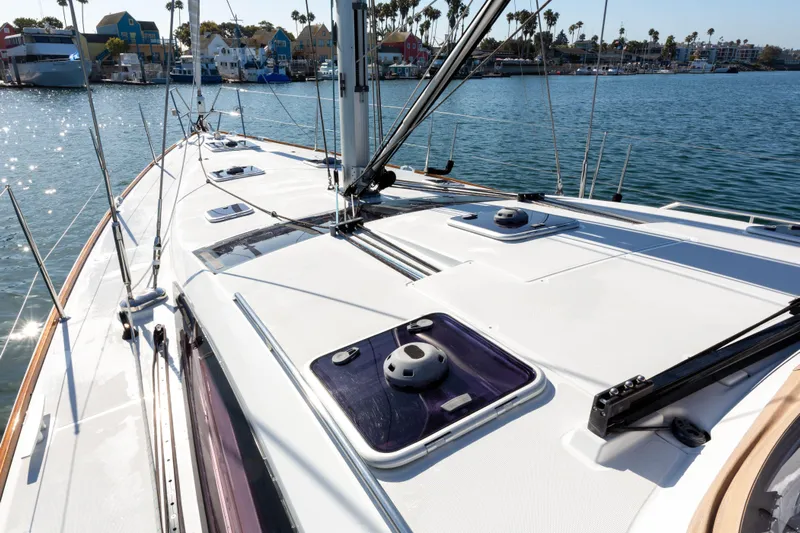 Shenanigans Yacht Photos Pics Jeanneau 53DS 2015 sailboat deck with marina view in the background.