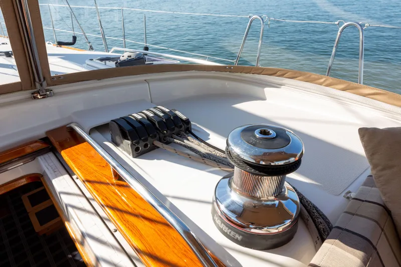 Shenanigans Yacht Photos Pics Jeanneau 53DS 2015 yacht deck with winch and ropes, overlooking calm sea.