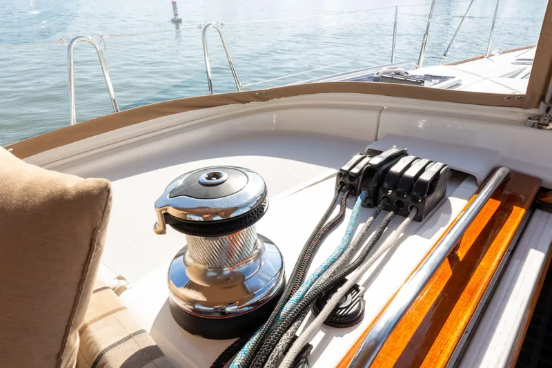 Shenanigans Yacht Photos Pics Jeanneau 53DS 2015 sailboat deck with winch and ropes, sunny day on the water.