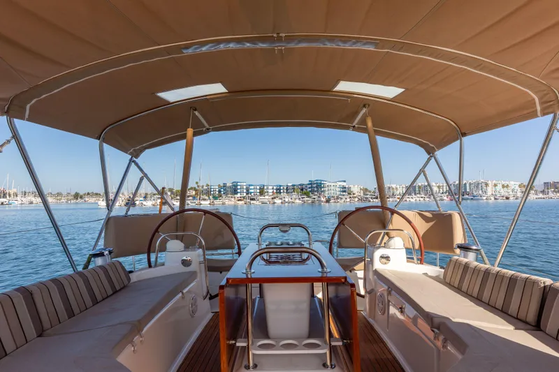 Shenanigans Yacht Photos Pics 2015 Jeanneau 53DS yacht cockpit with canopy, overlooking marina.