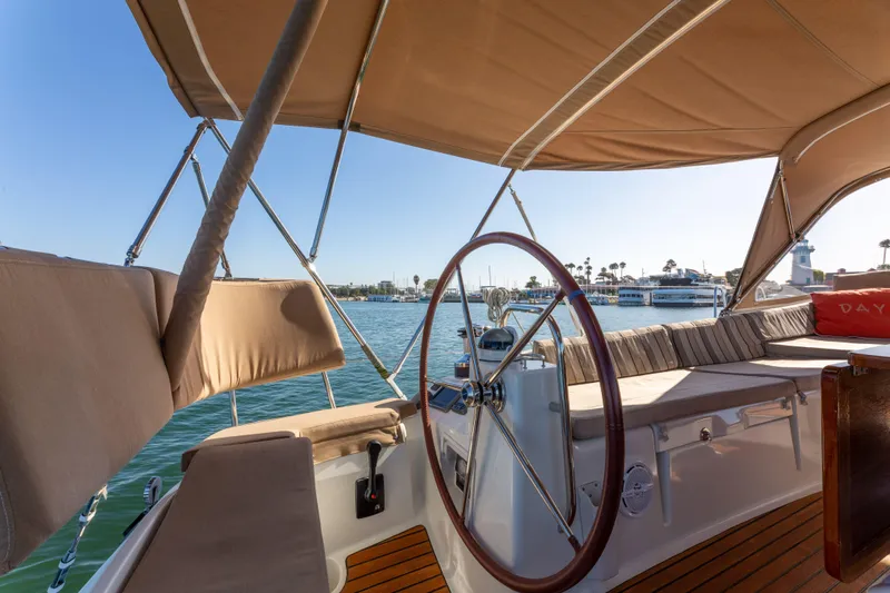 Shenanigans Yacht Photos Pics Cockpit view of 2015 Jeanneau 53DS sailboat with steering wheel and seating.