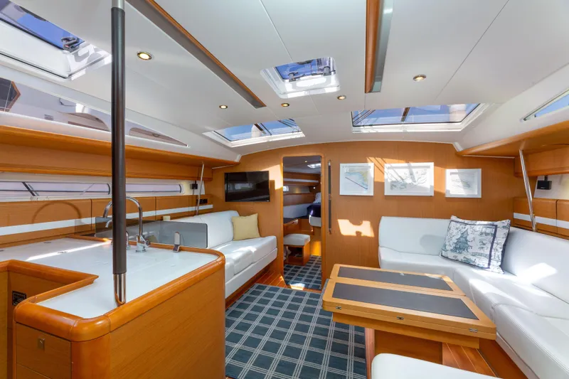 Shenanigans Yacht Photos Pics Luxurious interior of 2015 Jeanneau 53DS yacht with modern furnishings and ample natural light.