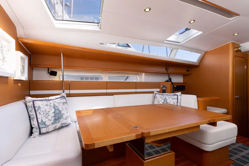 Shenanigans Yacht Photos Pics Luxurious interior of 2015 Jeanneau 53DS sailboat with elegant wood finish and skylights.