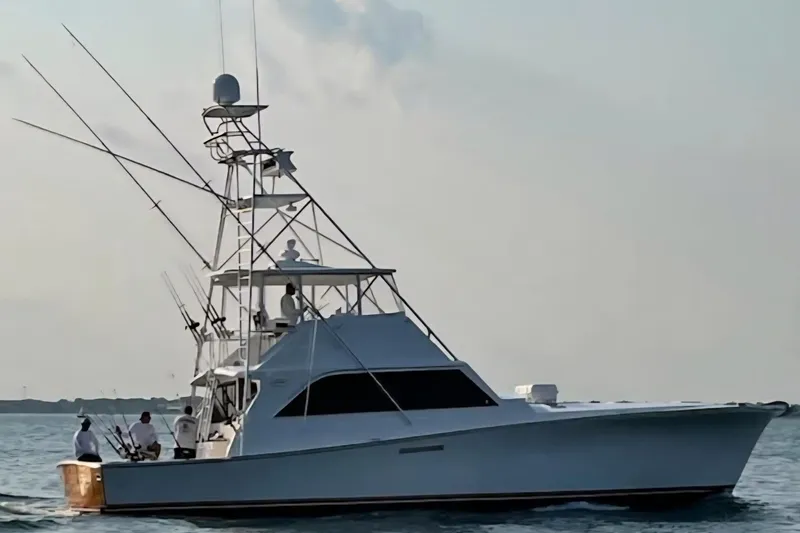  Yacht Photos Pics Ocean Yachts 55 Super Sport 1982 model cruising on calm waters at sunset.