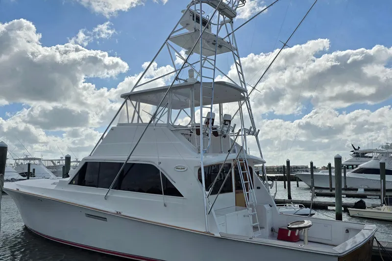  Yacht Photos Pics Ocean Yachts 55 Super Sport 1982 model docked under a partly cloudy sky.