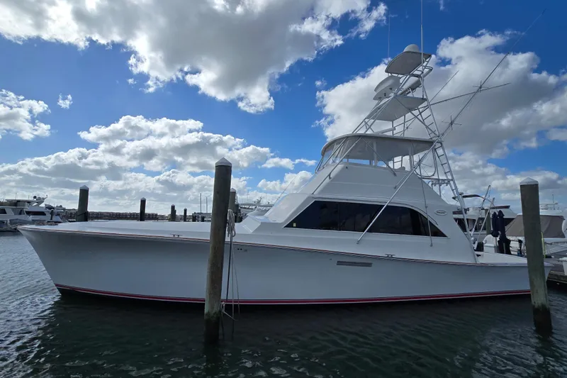  Yacht Photos Pics Ocean Yachts 55 Super Sport 1982 model docked under a partly cloudy sky.