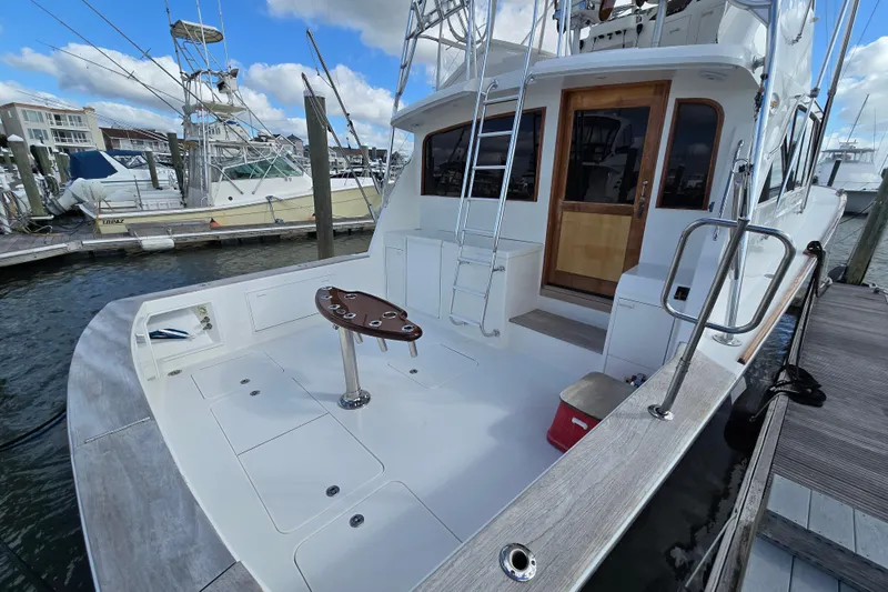  Yacht Photos Pics Ocean Yachts 55 Super Sport 1982 model docked, featuring spacious deck and fishing chair.