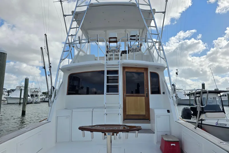  Yacht Photos Pics Ocean Yachts 55 Super Sport 1982 model, docked with ladder and fishing setup.