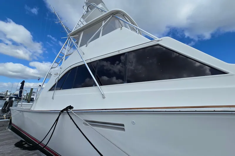  Yacht Photos Pics Ocean Yachts 55 Super Sport 1982 model, docked under a blue sky with clouds.
