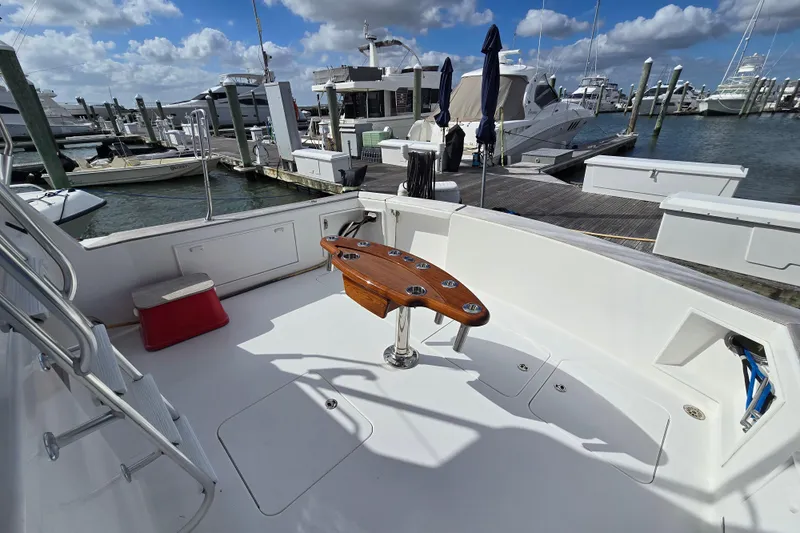  Yacht Photos Pics Ocean Yachts 55 Super Sport 1982, spacious deck with fishing chair, docked at marina.