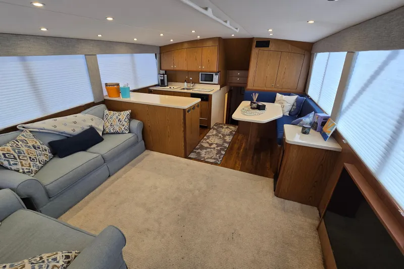  Yacht Photos Pics Luxurious interior of 1982 Ocean Yachts 55 Super Sport, featuring cozy seating and modern kitchen.