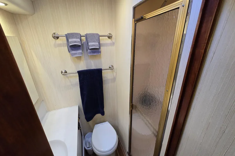  Yacht Photos Pics Bathroom interior of Ocean Yachts 55 Super Sport, featuring shower and towels, 1982 model.