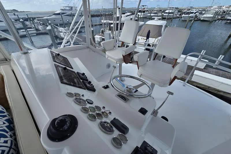  Yacht Photos Pics Cockpit of Ocean Yachts 55 Super Sport 1982, featuring helm and gauges at marina.