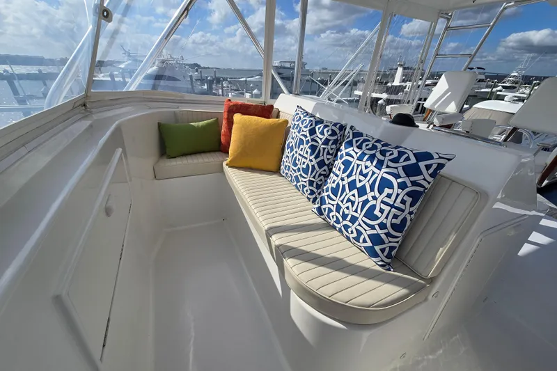  Yacht Photos Pics Luxurious seating area on Ocean Yachts 55 Super Sport, featuring colorful cushions and marina view.