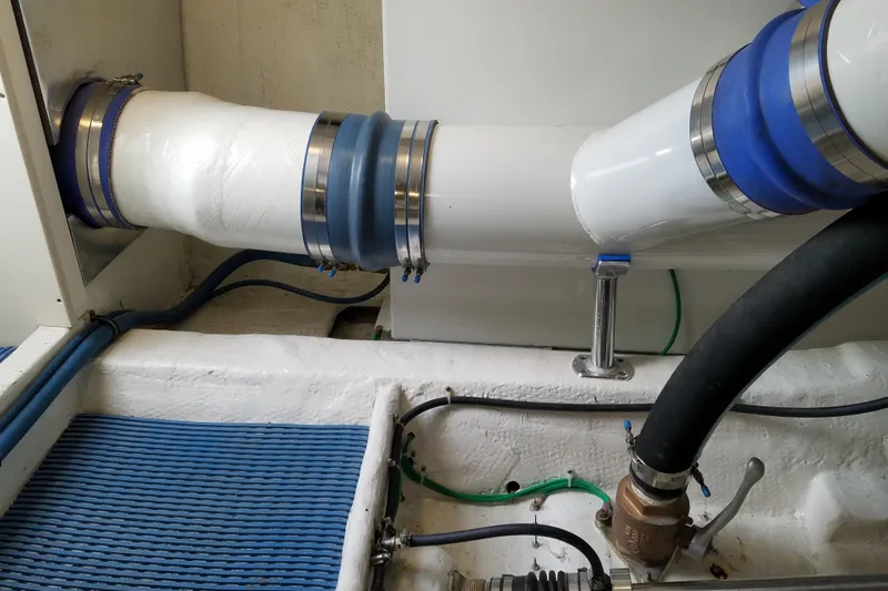  Yacht Photos Pics Engine room piping of Ocean Yachts 55 Super Sport, 1982 model, featuring blue and white components.