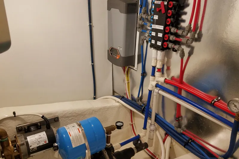  Yacht Photos Pics Engine room of Ocean Yachts 55 Super Sport 1982, featuring plumbing and electrical systems.