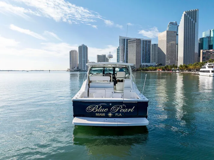 Blue Pearl Yacht Photos Pics 2004 Tiara Yachts 4200 Open, "Blue Pearl," in Miami waters with city skyline.