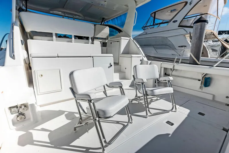 Blue Pearl Yacht Photos Pics 2004 Tiara Yachts 4200 Open deck with chairs, showcasing luxury and comfort.