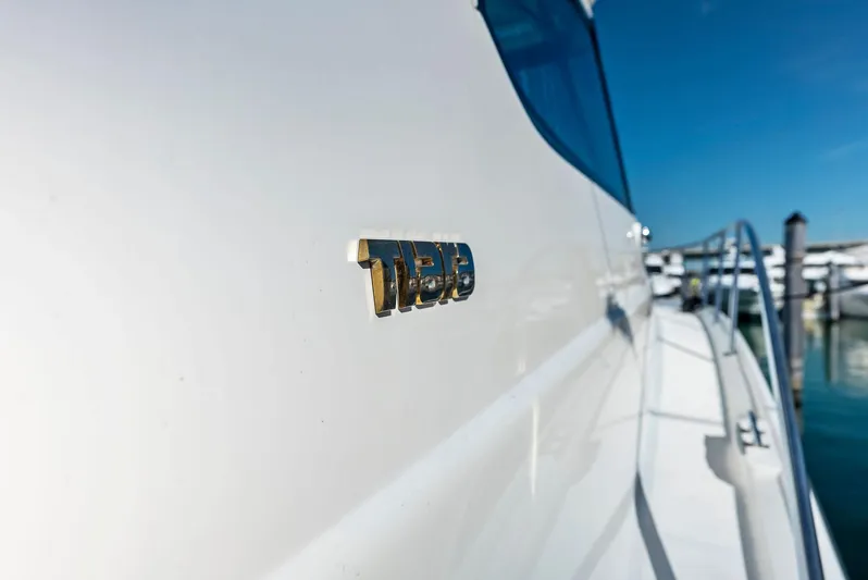 Blue Pearl Yacht Photos Pics 2004 Tiara Yachts 4200 Open, side view with logo, docked in marina.