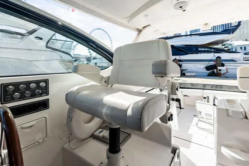 Blue Pearl Yacht Photos Pics 2004 Tiara Yachts 4200 Open helm seat with marina view.