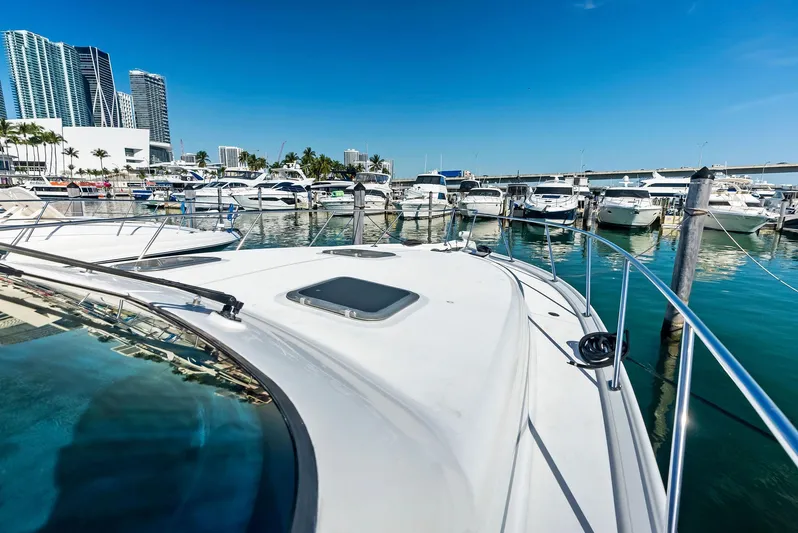 Blue Pearl Yacht Photos Pics Tiara Yachts 4200 Open 2004 docked in a marina with city skyline.