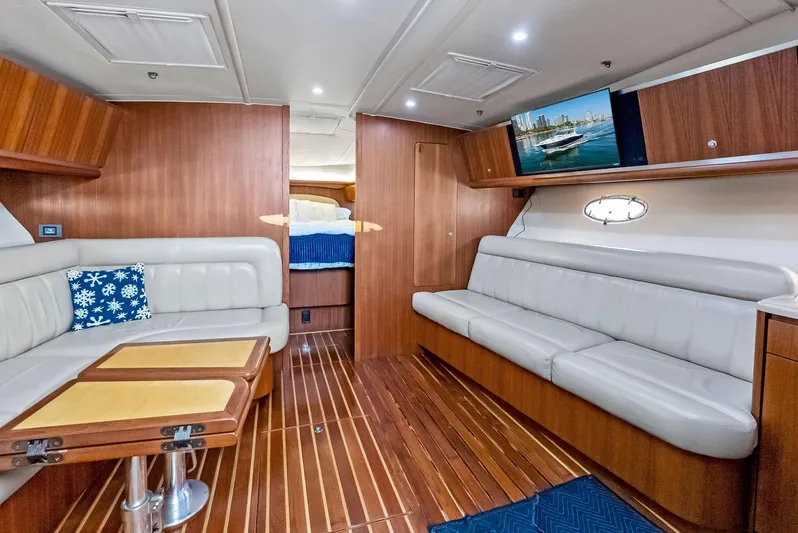 Blue Pearl Yacht Photos Pics Luxurious interior of 2004 Tiara Yachts 4200 Open with elegant wood finish and plush seating.