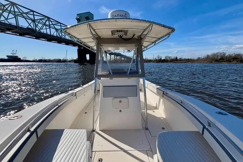  Yacht Photos Pics 2006 McKee Craft Freedom 28 FS/CC boat on water near a bridge, clear sky.