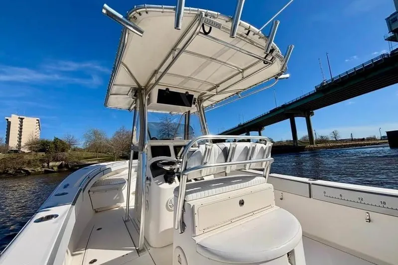  Yacht Photos Pics 2006 McKee Craft Freedom 28 FS/CC boat on water near a bridge, clear sky.