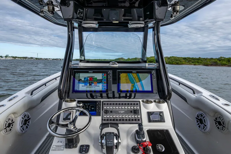 Going Propless Yacht Photos Pics Cockpit view of 2020 Tidewater 320 CC Adventure boat with navigation screens.
