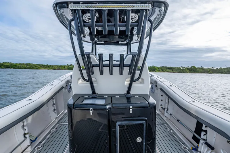 Going Propless Yacht Photos Pics 2020 Tidewater 320 CC Adventure boat interior with rod holders on a calm water backdrop.