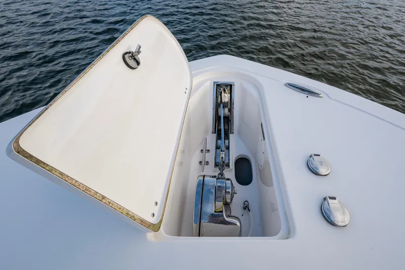 Going Propless Yacht Photos Pics 2020 Tidewater 320 CC Adventure boat anchor compartment open on calm water.