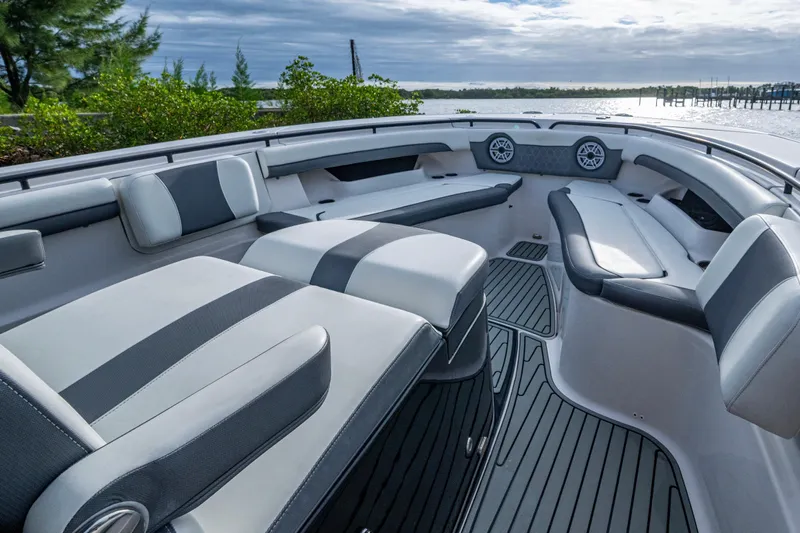 Going Propless Yacht Photos Pics 2020 Tidewater 320 CC Adventure boat interior with cushioned seating and scenic water view.