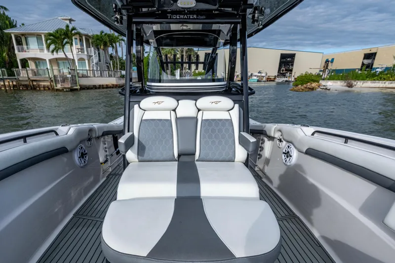 Going Propless Yacht Photos Pics 2020 Tidewater 320 CC Adventure boat interior with luxurious seating and waterfront view.