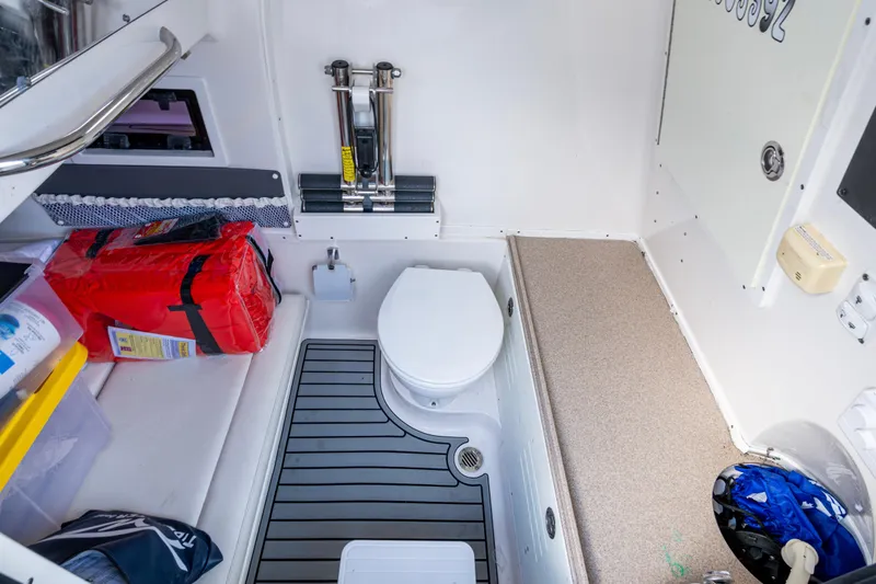 Going Propless Yacht Photos Pics 2020 Tidewater 320 CC Adventure boat interior with toilet and storage area.