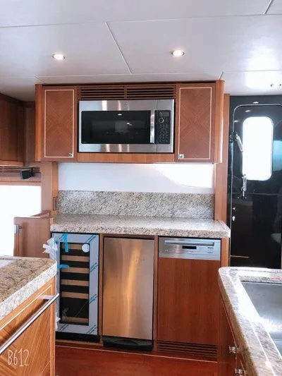  Yacht Photos Pics Modern kitchen in 2026 Selene 60 Explorer yacht with granite countertops and stainless steel appliances.