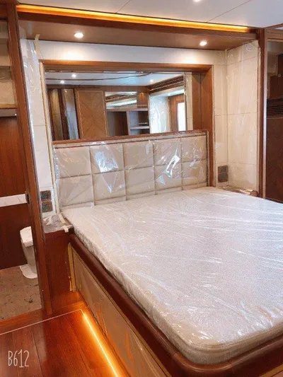  Yacht Photos Pics Luxurious bedroom interior of 2026 Selene 60 Explorer yacht with elegant wood finishes.