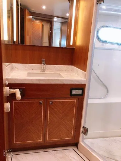  Yacht Photos Pics Luxurious bathroom in 2026 Selene 60 Explorer yacht with wood cabinetry and marble countertop.