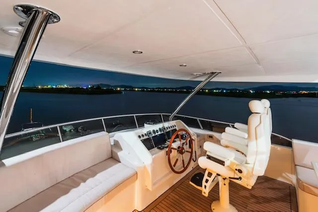  Yacht Photos Pics Luxurious Selene 60 Explorer yacht helm at night, featuring plush seating and modern controls.