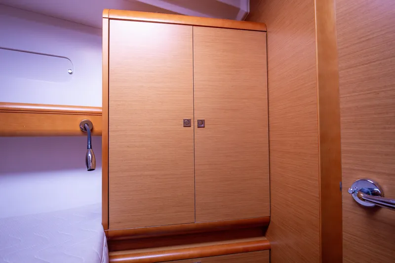  Yacht Photos Pics Interior cabin of 2013 Jeanneau Sun Odyssey 439 yacht with wooden cabinetry.