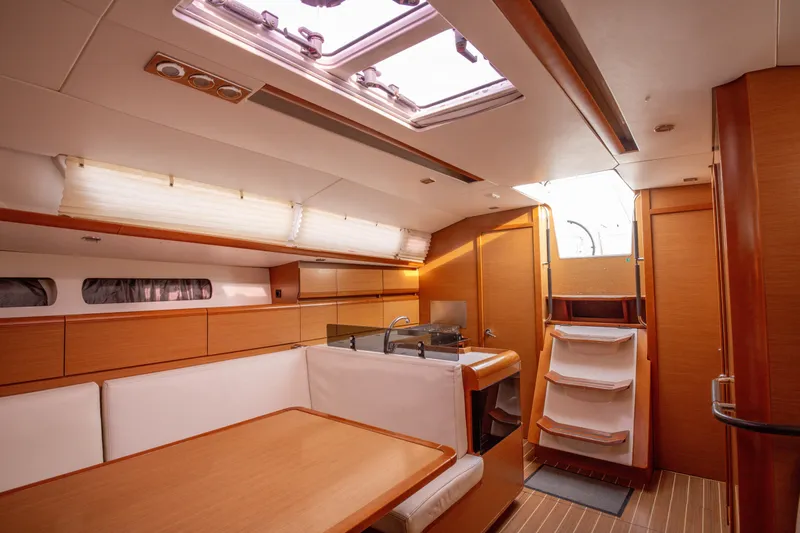  Yacht Photos Pics Interior of 2013 Jeanneau Sun Odyssey 439 yacht, featuring modern wood finish and spacious layout.