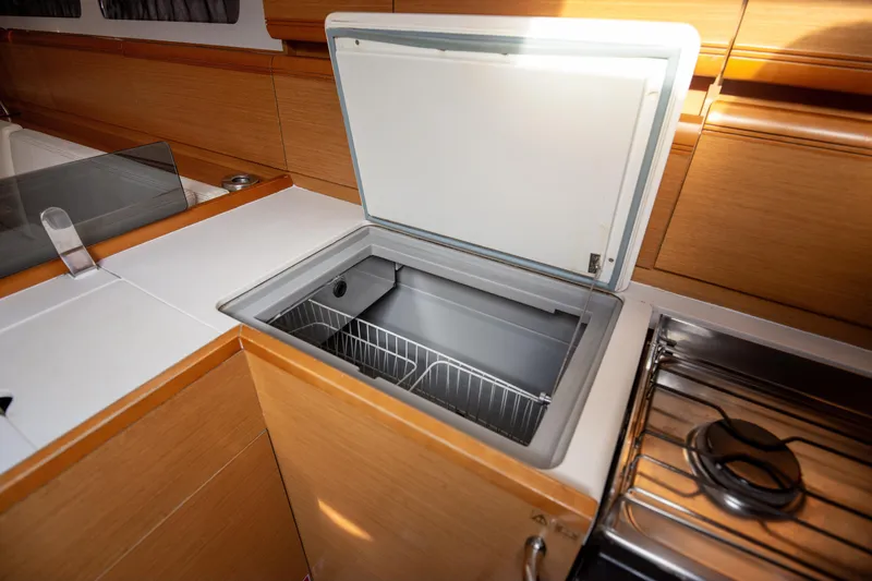  Yacht Photos Pics Open fridge in 2013 Jeanneau Sun Odyssey 439 yacht kitchen interior.