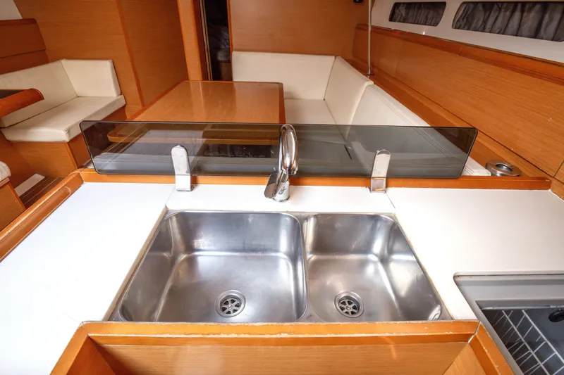  Yacht Photos Pics Interior of 2013 Jeanneau Sun Odyssey 439 yacht, featuring a modern kitchen sink.